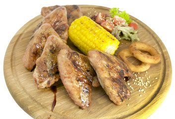 chicken wings with sweet corn on a wooden plate