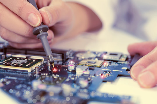 Technological background with closeup on tester checking motherb
