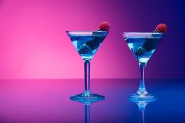 Fototapeten Colorful cocktails garnished with berries © andreaobzerova