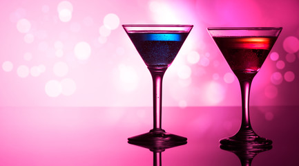 Colorful cocktails on reflective top, with bokeh background