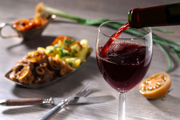 Pouring red wine and food