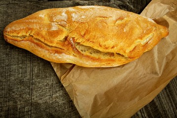 wheat bread on a wooden background