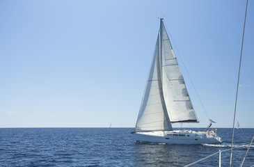 Obraz premium Sailing boat yacht or sail regatta race on blue water.