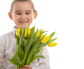 smiling little boy giving tulips