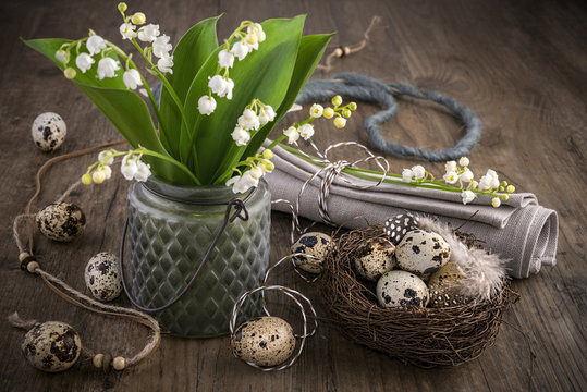 Lily of the valley and Easter decorations on old wood