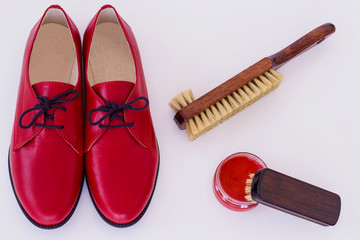 Isolated red shoes and means on care of footwear - shoe-polish a