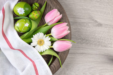 Easter background with painted eggs and spring flowers
