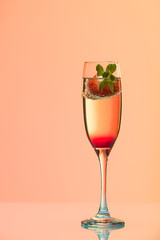 Champagne glass with strawberry, studio shot with light effects