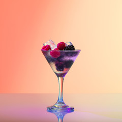 Raspberry and blackberry cocktail with ice, studio shot