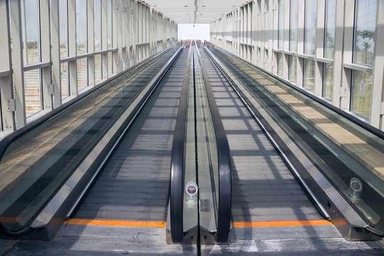 Tape escalator in glazed tunnel