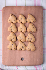 Heart shaped cookies  on a chopping board.
