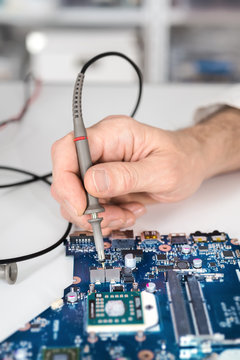Male tech tests electronic equipment