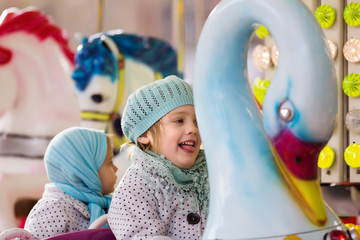  girls having ride on the merry-go-round