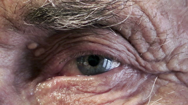 macro of an blue eye of an old man