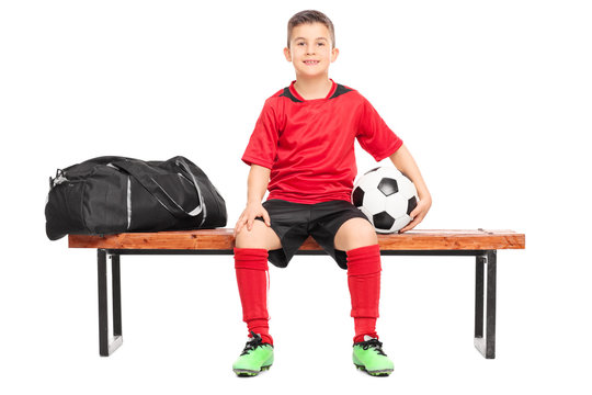 Junior soccer player sitting on a bench