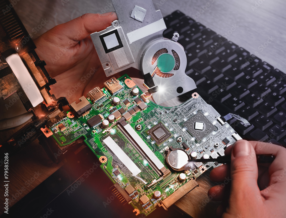 Poster tech fixes laptop motherboard in service center