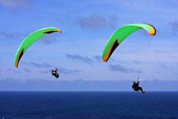 paragliders over the sea