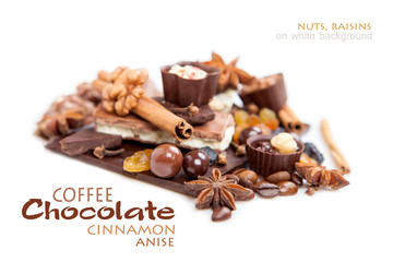 Various pieces of chocolate with nuts, raisins and coffee beans