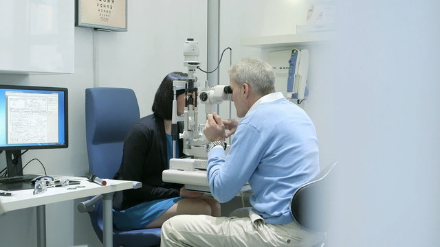 MS Female patient is examined by the Male Optician using the machine