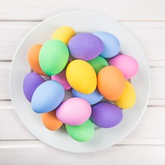 Fototapeta na wymiar Colorful pastel easter eggs on white wooden background