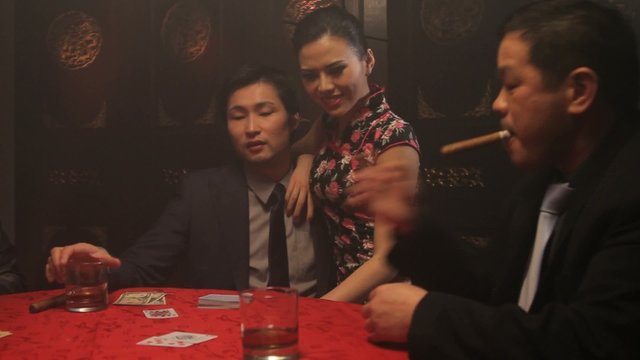 Businessmen playing cards in Casino