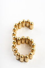 Numbers made of 9 mm cartridges on white background