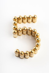 Numbers made of 9 mm cartridges on white background