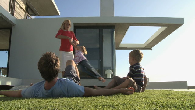 MS OF A FAMILY PLAYING IN A GARDEN