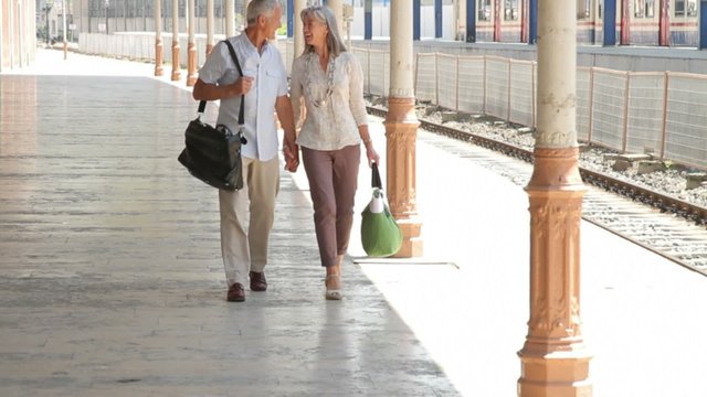 Couple walking on Railstation platform and embracing, Istanbul Turkey