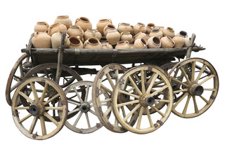 Old wooden cart full of clay pottery and wheels isolated over wh