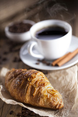Delicious coffee with sweets on a wooden table