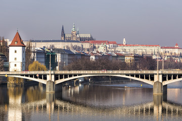 Panorama of Prague and bridge with reflection over river Vltava.