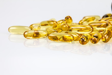 Closeup yellow soft gelatin supplement fish oil capsule