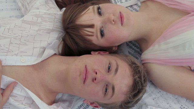Young Man And Woman Lying Together. Open Eyes