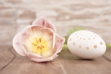 Obraz na płótnie Canvas Easter egg and a flower, tinted image, space
