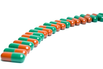Capsules in a row on white background