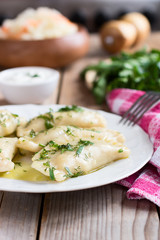  Varenyky on a white plate on wooden table