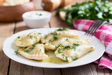  Varenyky on a white plate on wooden table