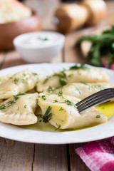  Varenyky on a white plate on wooden table