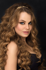 Portrait of gorgeous young woman with long curly hair