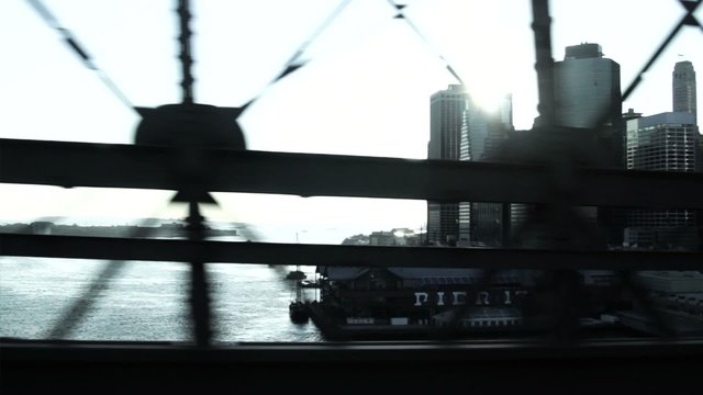 WS POV Car crossing East River with view of Manhattan Financial District and Brooklyn Bridge / New York, New York, USA