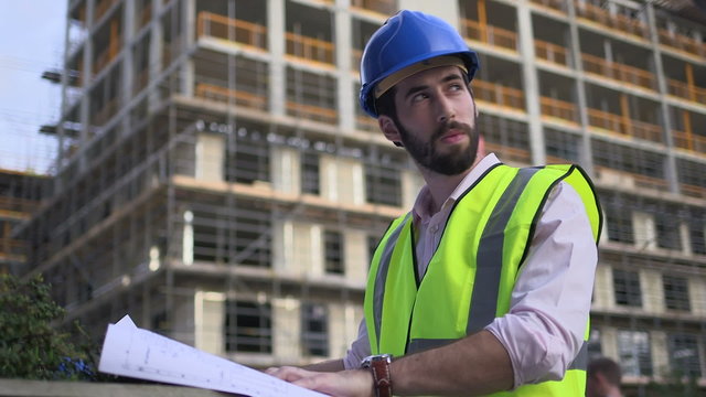 Male architect with blueprint 