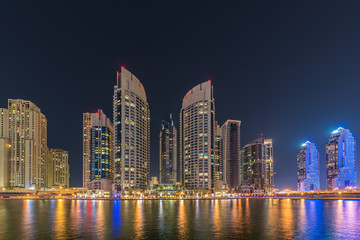 Naklejka na ściany i meble Dubai marina skyscrapers during night hours