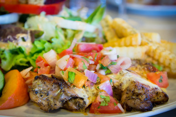 Chicken steak with vegetable sauce and salad