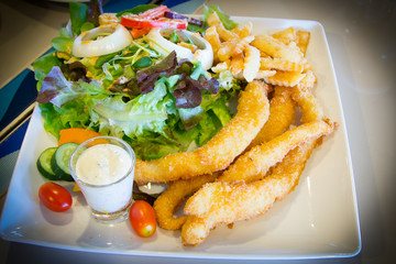 Fish and chips served with salad