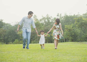 Fototapeta premium Happy Asian Family enjoying family time together in the park