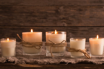 Fototapeta na wymiar scented candles on old wooden background