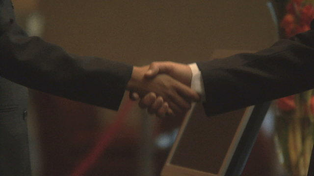 CU OF BUSINESSPEOPLE SHAKING HANDS