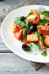 Summer salad with vegetables and croutons on a plate