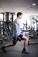 Fototapeta na wymiar Leg split with weights, quadriceps exercises